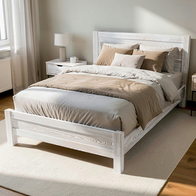 White wooden bed with beige bedding in a bright bedroom