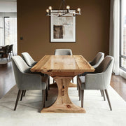 Dining room with wooden table and gray chairs against a brown wall.
