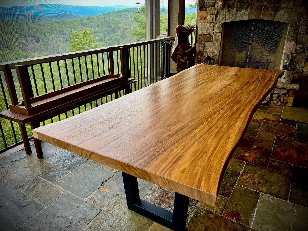 Wooden dining table with a scenic view from a balcony
