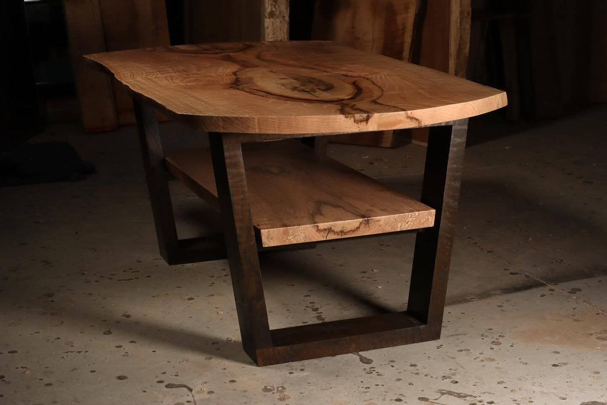 Rustic wooden coffee table with natural wood grain and dark metal frame, featuring a sturdy lower shelf.